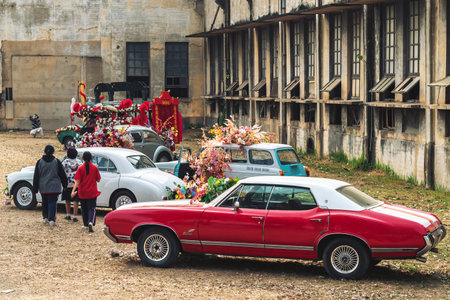 KANCHANABURI,THAILAND-FEBRUARY 12,2024 : An exhibition of beautiful antique cars decorated with artificial flower bouquets on lawn at The old paper mill. Vintage car with beautiful flower bouquet.のeditorial素材