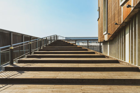 Beautiful modern architecture concept design of wooden stair and handrail with surface texture at walking entrance of modern exhibition hall building. Beautiful wooden staircase.の写真素材