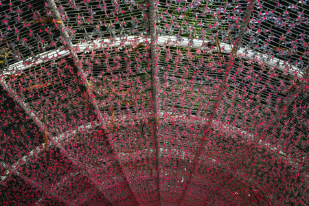 Red colorful abstract light art decoration. Festival light decoration for celebration outdoor. Glowing decorative tunnel. Beautiful tunel line Lighting illumination and decoration items for festival.の写真素材