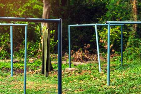 Towels hanging laundry on washing line at backyard. Clothesline with fresh washed towels outdoors at home. Fresh clean towel drying on washing line. Laundry hung on clothesline made of stretched wireの写真素材