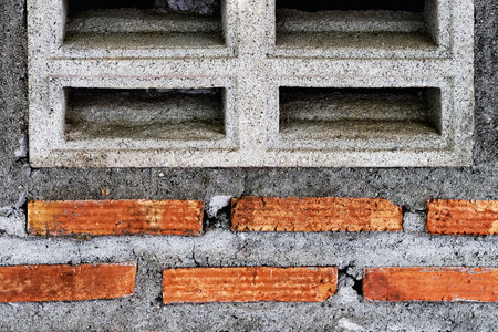 Old dirty cement ventilation block and red brick wall. Abstract hollow concrete cement brick block texture background. Wind ventilation on home and building made of brick. Old concrete air ventilationの写真素材