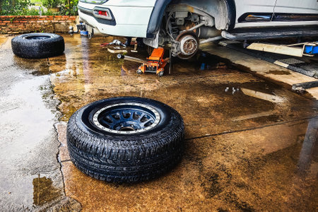 Change new car tires. Process of checking the condition of new tires. Repair tire puncture. Checking and filling air pressure. Car repairs. Car breakdowns. Concept of car tire maintenance and repairの写真素材