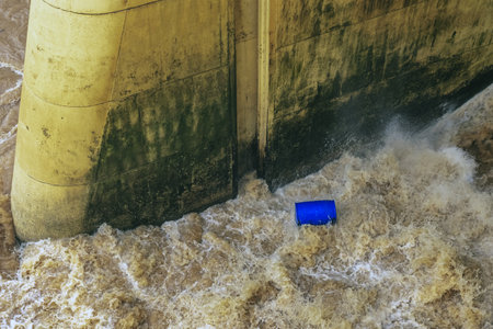 Water flows profusely. River water flowing profusely. Flood waters rushing down river after storm...