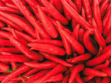 Full frame many red chilies for cooking Asian food. Herb and food ingredient. Chilli pepper. Pile of red chillies spicy background texture. Fresh Thai chili red pepper for spicy ingredient in food.の写真素材