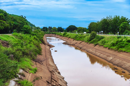Irrigation canal or irrigation channel in cracked concrete wall send water from reservoir to...