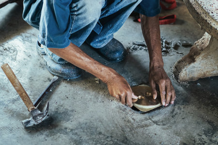 Elderly worker of water utility maintenance service change sewer manholes in house. Hands of old man...