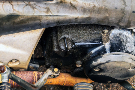 Old and expired motorcycle oil filler cap is loose and evaporated motorcycle engine oil stains. Dirty engine motorcycle. Oil stains to adhere to the motorbike engine. Old engines lack maintenance.の写真素材