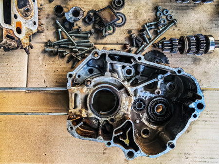 Old parts of motorcycles background. Repair and maintenance old parts of engine. Old motorcycle spare parts on corrugated paper background. Disassembly of spare parts, gear, differential, engine, old.の写真素材