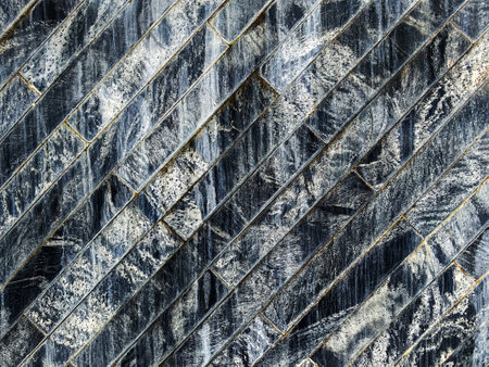 Contemporary and Luxury style marble brick wall pattern background with flow water. Decorative Water flow on stone wall made of granite panels wallpaper. Patterned wall with rectangular tiles backdropの写真素材