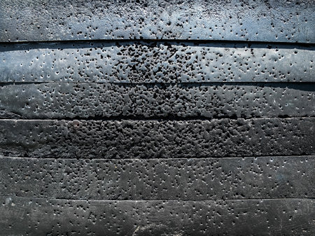 Holes on rubber target surface caused by archery practice. Rubber of archery target damaged by arrows. Black material competition target to absorb and hold arrows after firing. Rubber archery target.の写真素材
