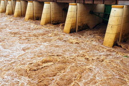 Smudged water flows profusely. River water flowing profusely. Flood waters rushing down river after...