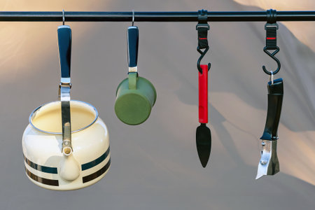 Stainless steel kettle and sets of camping equipment in form of tents and camping. Compact equipment...