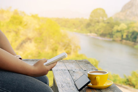 Hands of young woman using two phones simultaneously. Happy woman use two modern smartphones synchronize devices. Young female hold old new cellphone browse internet send data. Technology concept.の写真素材