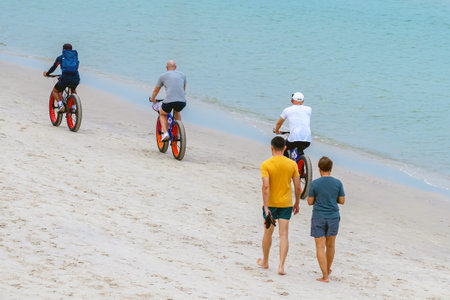 Carefree man in sports fitness clothes riding Fat bike also called fatbike or fat-tire bike in...
