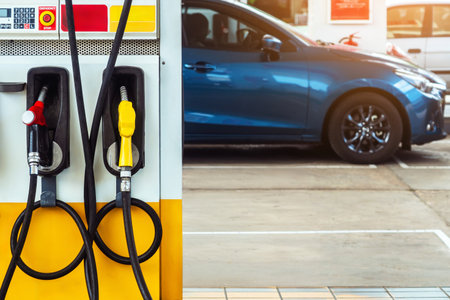 Petrol fuel nozzle for fuelling in petrol fuel station. Hand refilling car with fuel at refuel station. Nozzle pump petroleum fuel. Fuel dispensing pump. Fuel and Business service energy concept.の写真素材