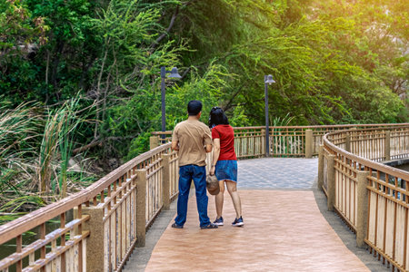 Back view of tourists come to visit and enjoy walking on the walkway with beautiful nature scenic landscape with stone mountain range also call Snake Mountain at Khao Ngu Stone Park. Amazing nature.の写真素材
