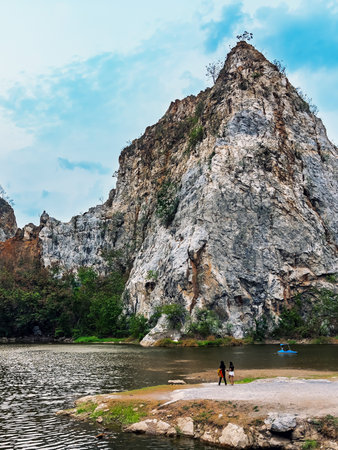 Back view of Asian female friends enjoy with beautiful nature scenic landscape with stone mountain range also call Snake Mountain at Khao Ngu Stone Park. Amazing nature. Happy outdoors together.の写真素材