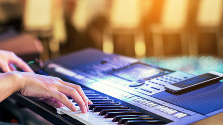 Hands of male musician press digital electronic keyboard synthesizers on concert stage. Pianist man...