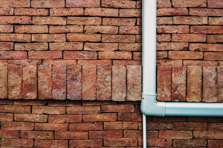 Ventilation system. Air conditioner duct cover or Slim Duct or Duct liner installed on brick wall to protect refrigerant lines and keep installation neat and tidy. Air conditioning refrigerant pipe.の写真素材
