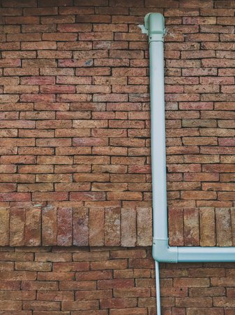 Ventilation system. Air conditioner duct cover or Slim Duct or Duct liner installed on brick wall to protect refrigerant lines and keep installation neat and tidy.の写真素材