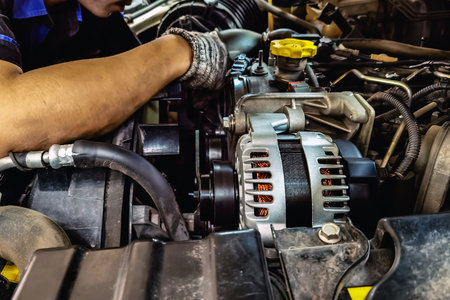 Close up to alternator or electrical generator under the hood of pick up car with blurred image of...