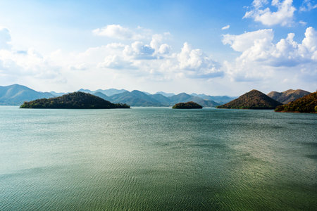 Beautiful view of Srinagarind Dam reservoir in Kanchanaburi, Thailand. Landscape with mountains.