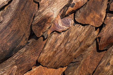 Weathered wooden planks texture background. Stacked reclaimed scrap wood pieces with charred edges....