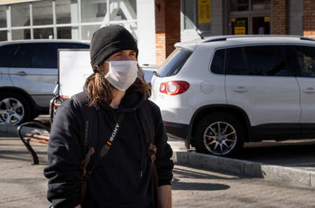 Lutsk, Ukraine - April 20,2020: A man wearing face mask on a public streets in the middle of...