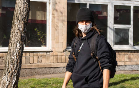 Lutsk, Ukraine - April 20,2020: A man wearing face mask on a public streets in the middle of...