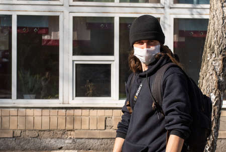 Lutsk, Ukraine - April 20,2020: A man wearing face mask on a public streets in the middle of...