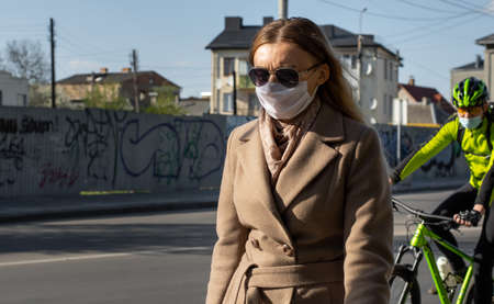 Lutsk, Ukraine - May 20,2020: A woman wearing face mask on a public streets in the middle of...
