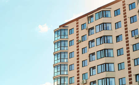 New residential apartment condominium type. View of modern sand stucco facade with big bay window...