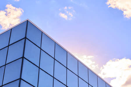 Lutsk, Ukraine - May 22,2020: business house with glass facade cladding or panel windows. Retail building with glazed curtain walling exterior at sky. City real estate. Urban mall office architectureのeditorial素材