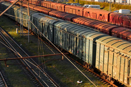 Lutsk, Ukraine - May 26,2021: Cargo train with goods wagon on rails. Roofs of locomotive with...