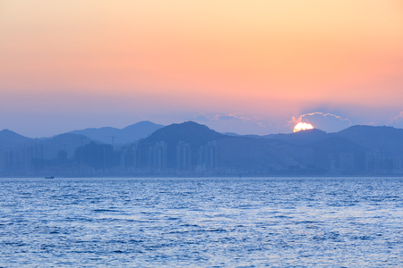 Sunset with sea and mountains in xiamen, Chinaの写真素材