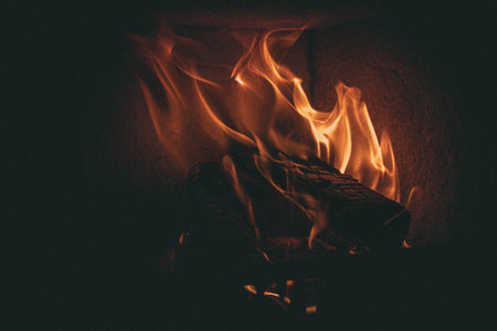 Fire in the fireplace. Fireplace in the dark. Firewood burning in the fireplace.の写真素材