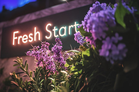 Fresh Start Sign with a bunch of purple flowers in the background.の素材