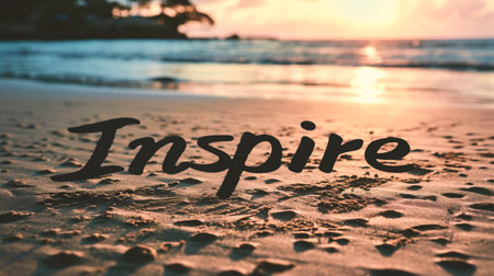Inscription Inspire on the sand of a tropical beach at sunsetの素材