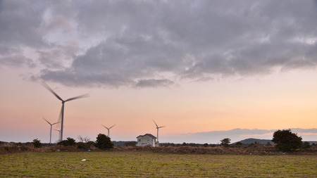 Eletric Power Generator Wind Turbine over a Cloudy Sky