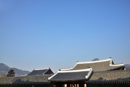 tiled roofs of Gyeongbokgung with clear sky in Seoul, Koreaのeditorial素材