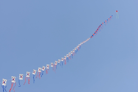 lots of Taegeukgi patterned kites in a row with clear skyの写真素材