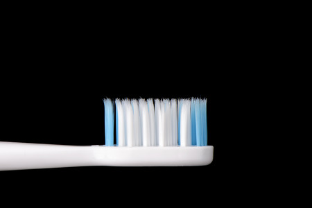 closeup of Used toothbrush, isolated on blackの写真素材