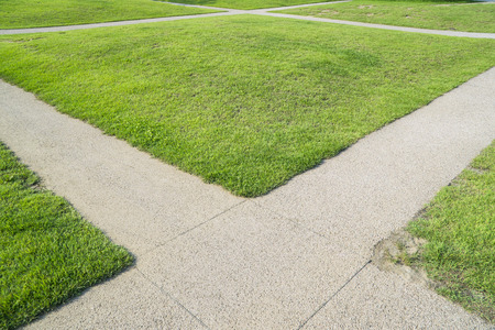 green grass and cross path in a fieldの写真素材