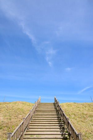 wooden stairs at a hill with blue skyの写真素材