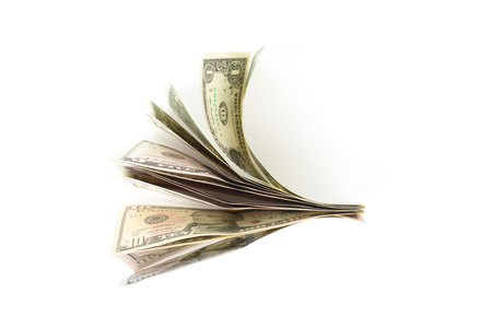 Spread bundle of US bills, isolated on whiteの写真素材
