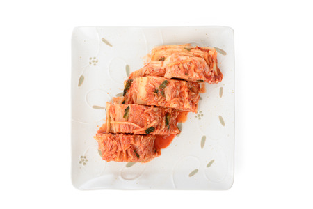 cutted Gimchi in a white dish, isolated on whiteの写真素材