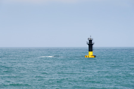 Lighthouse alert for sunken rock  near the Iho Teu Beach in Jeju Island, Korea.の写真素材