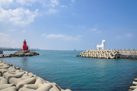 horse shaped lighthouse on a breakwater with tetrapod near the Iho Teu beach in Jeju Island, Korea.の写真素材