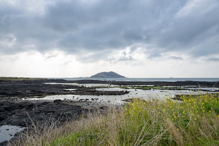 landscape of Biyangdo island in a cloudy day, view from Hyeopjae beach in Aewol in Jeju Island, Korea.の写真素材