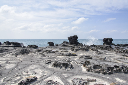 Landscape with distinctive geological rock coast in Jeju Island, Korea. It is near the Jeju Olle trail route 16.の写真素材